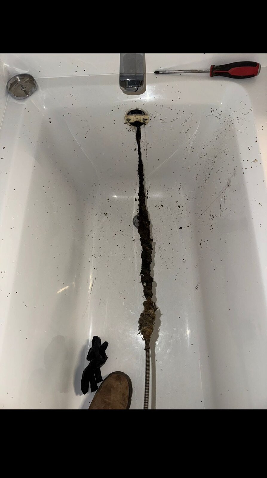 Bathtub drain cleared by HYDROPRO — hair clog removed by drain auger