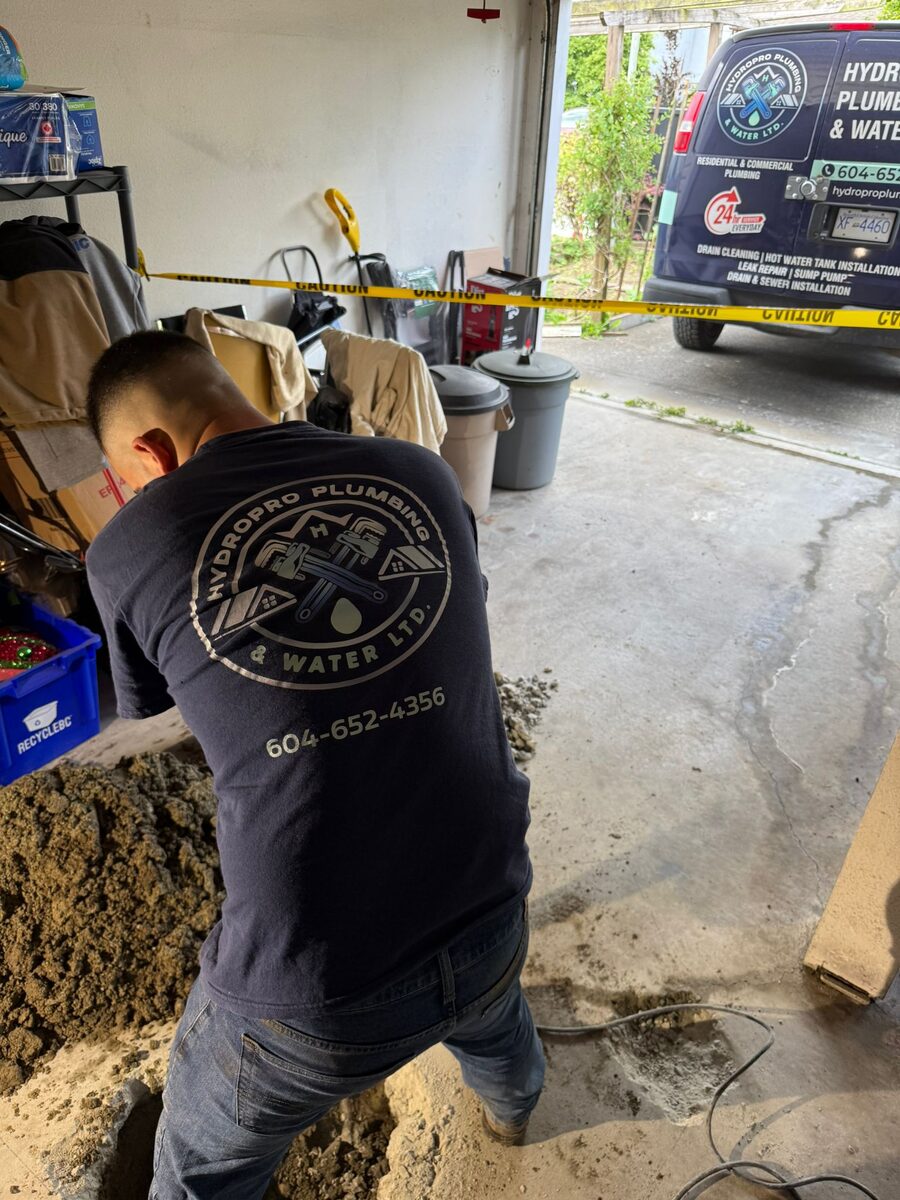 HYDROPRO plumber in branded uniform on a job site with the company service van in Greater Vancouver
